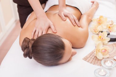 Cheerful slim girl is getting skin care treatment