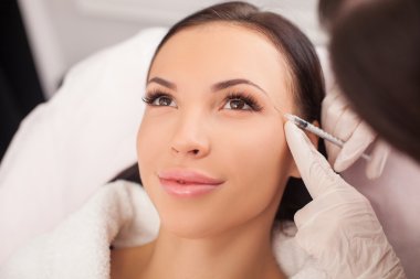 Attractive healthy lady is visiting expert beautician