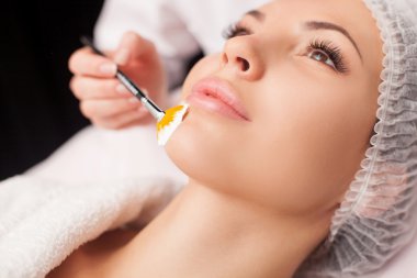 Cheerful healthy lady is visiting expert beautician