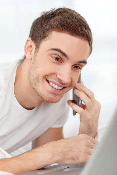 Cheerful guy is resting in his room — Stock Photo, Image