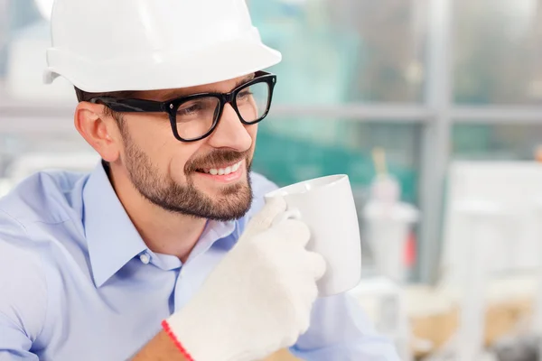 Alegre joven ingeniero descansa en un descanso — Foto de Stock