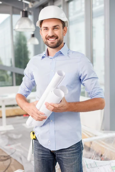 Attractive male architect is working with papers — Stockfoto