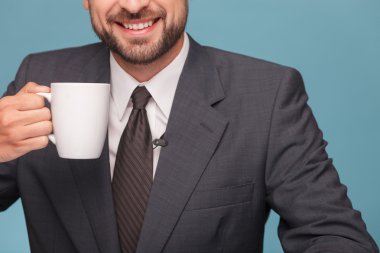 Cheerful mal reporter is enjoying hot tea