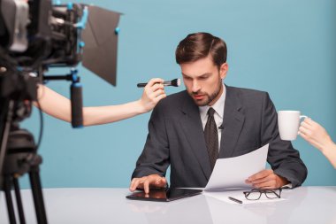 Cheerful male reporter before telling some news clipart