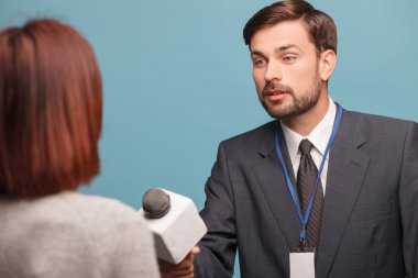 Attractive young journalist is interviewing the lady
