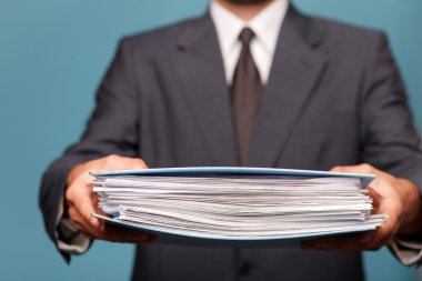 Cheerful male worker in formalwear with papers
