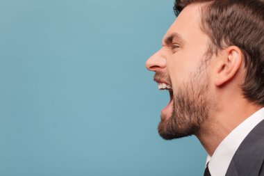 Attractive young businessman is expressing his emotions
