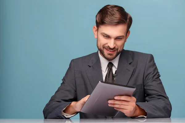 Handsome newscaster working at studio with laptop — Stock Photo, Image