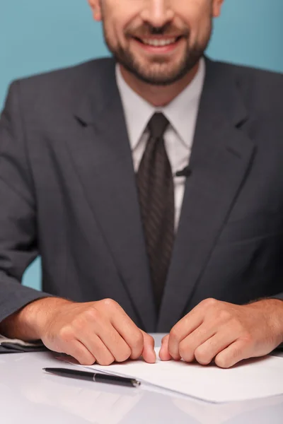 Cheerful male newscaster is making his report — 图库照片