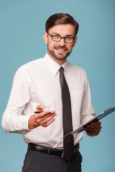 Attractive young businessman is working with papers — Stock Photo, Image