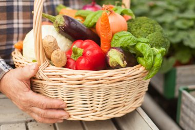 Cheerful senior male worker with fresh food