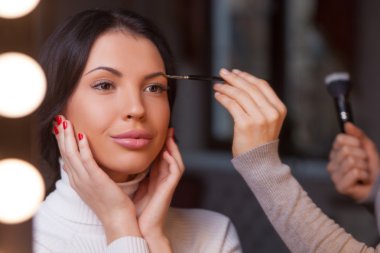 Experienced young beautician is working at beauty salon