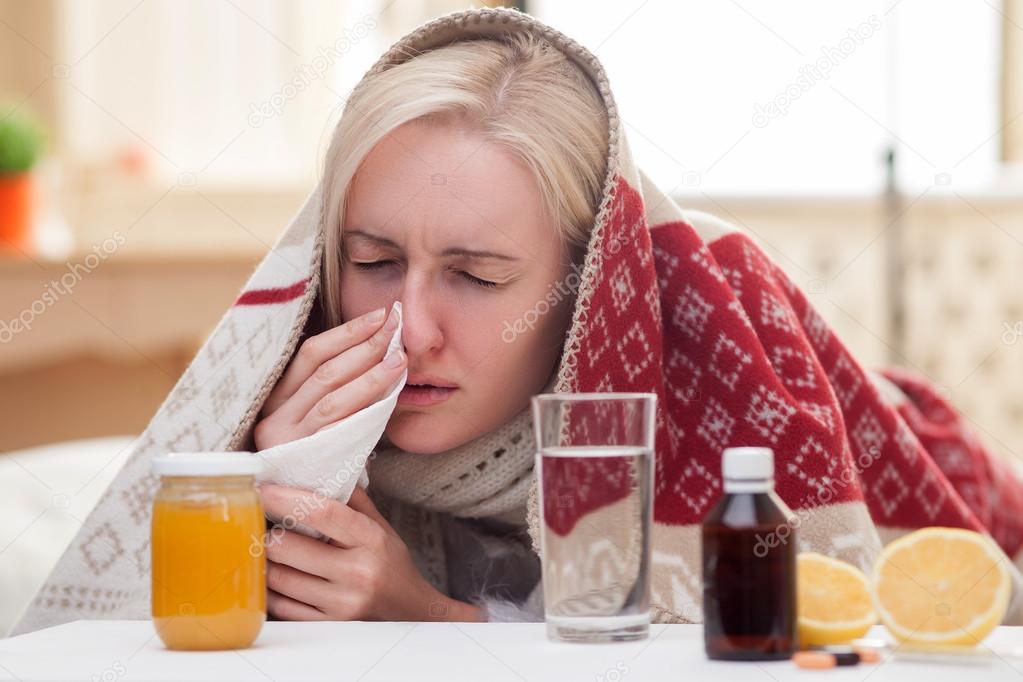 Ill young woman is suffering from flue