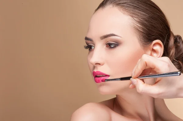 Hábil make-up artista está servindo seu cliente — Fotografia de Stock