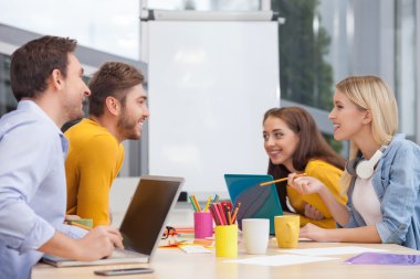 Attractive four colleagues are designing something new