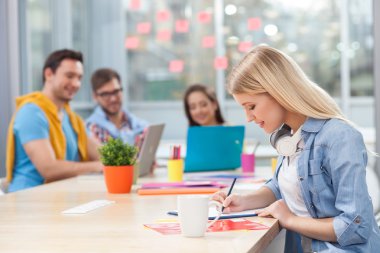 Attractive young designers are discussing new project