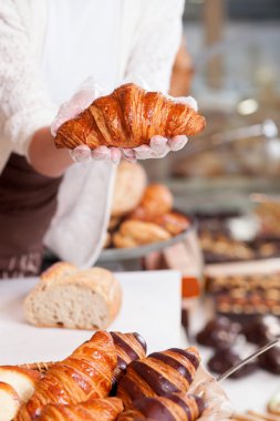 Cheerful female baker is working with joy