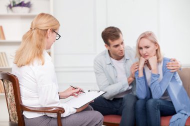 Cute husband and wife are trying marriage therapy