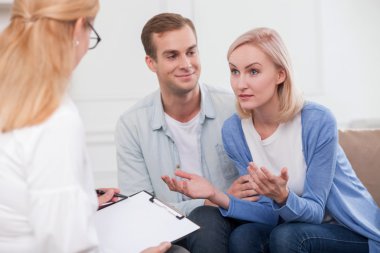 Cheerful young married couple needs an advice