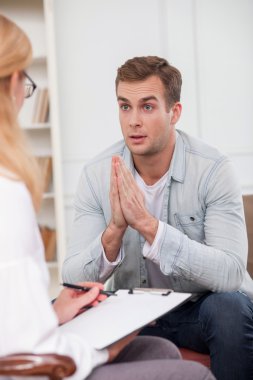 Attractive guy is attending professional female therapist