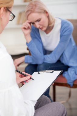 Cheerful female therapist is consulting her patient