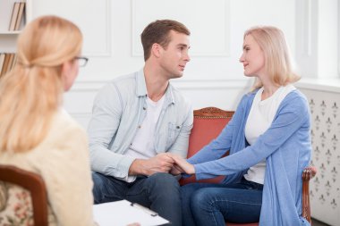 Attractive loving couple is visiting professional therapist
