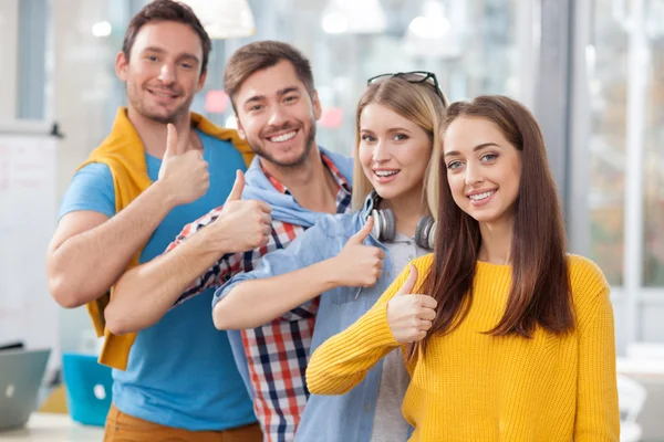 Skillful young colleagues are showing ok sign — Stockfoto