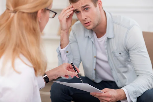 Cheerful young man has problems in his life — Stockfoto