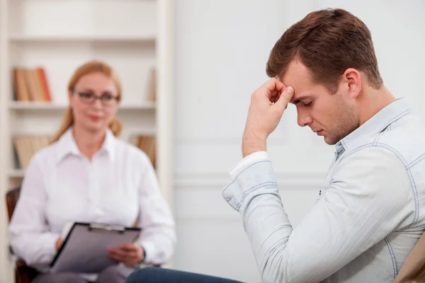 Upset guy is sharing his feelings to therapist — ストック写真