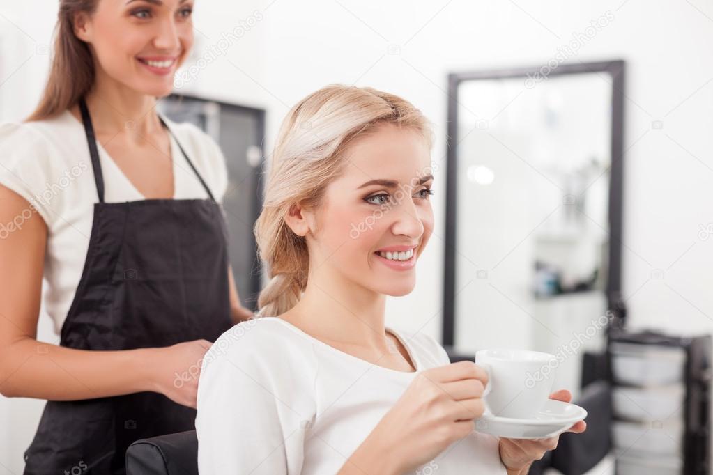 Beautiful blond girl is attending hairdressing saloon