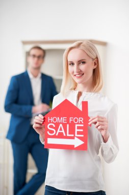 Beautiful blond lady is selling her house