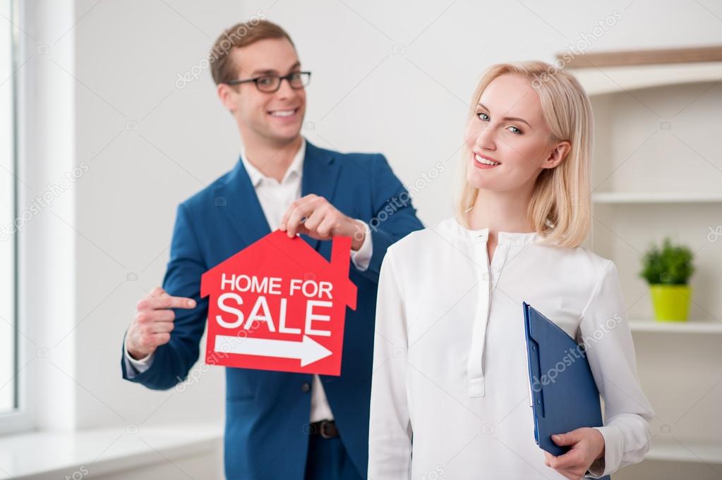 Cheerful estate agent is proposing to buy an apartment