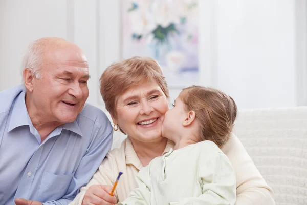 Pretty grandparents are taking care of child — Stockfoto