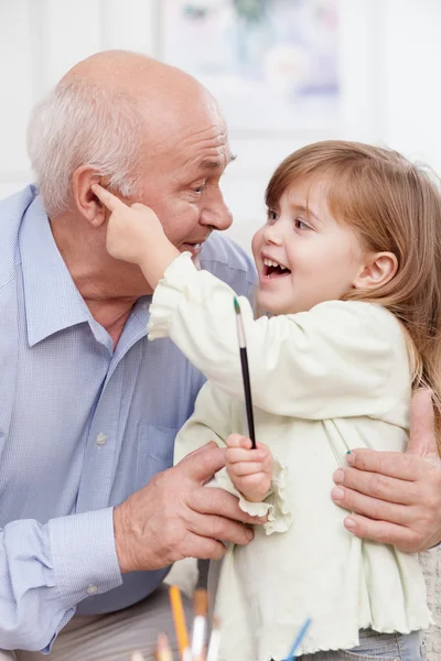 Cute friendly family is painting at home — Stockfoto