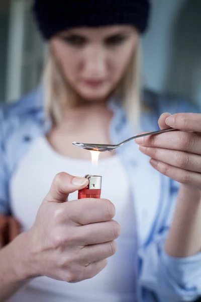 Addicted young female drug addict is preparing narcotic — Stockfoto