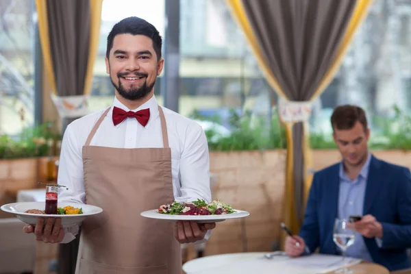 Attractive young waiter is working at restaurant — Stockfoto