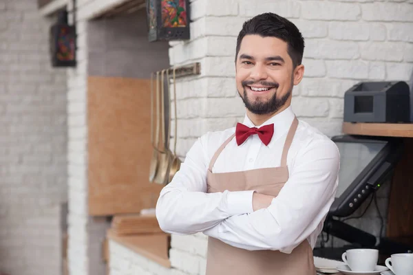 Handsome young waiter is working with joy — Stock Photo, Image