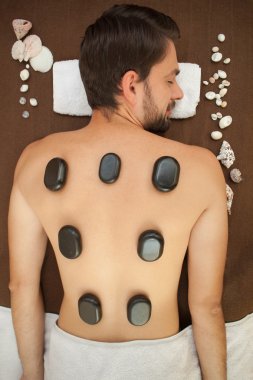 Pretty guy is getting massage at beauty salon