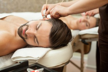 Pretty married couple is relaxing at beauty salon