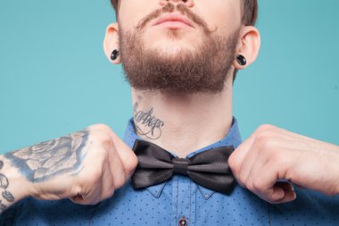 Cheerful young hipster is wearing a tie