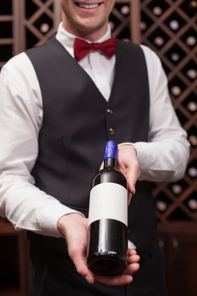 Cheerful young sommelier is working in cellar — ストック写真