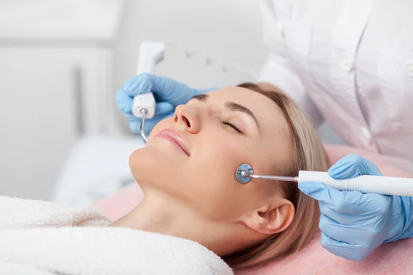 Cheerful blond girl is caring of her skin — Stock Photo, Image