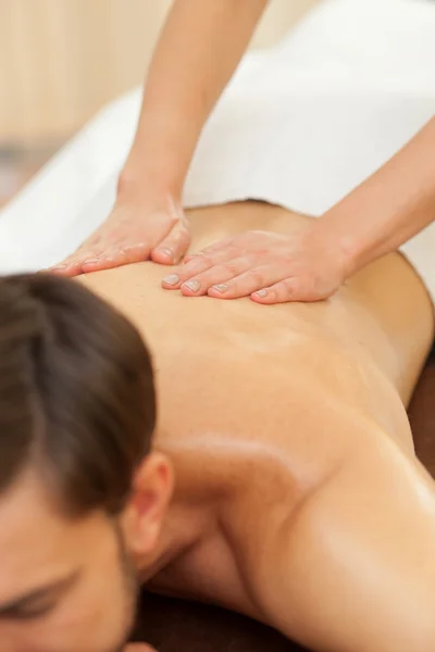 Experienced female therapist is massaging her customer — Stockfoto