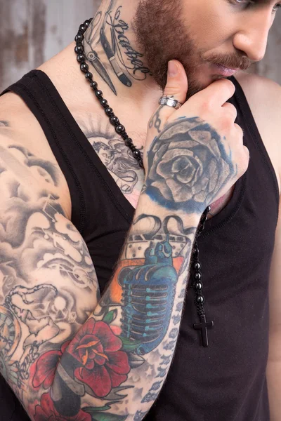 Cheerful tattooed man is making serious decision — Stockfoto
