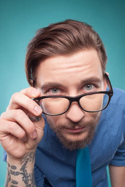 Handsome young man is examining something interesting — Stock Fotó