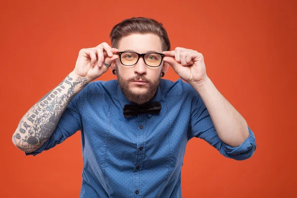 Cheerful bearded man is watching something interesting — Stock Fotó