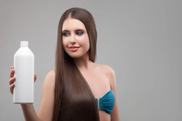 Cheerful healthy girl is presenting hair treatment — Stockfoto