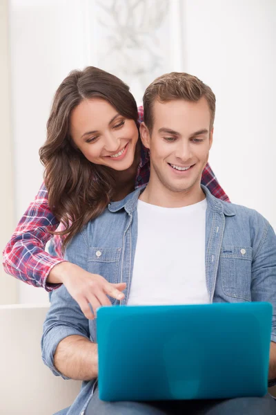 Beautiful husband and wife are using a laptop — 스톡 사진
