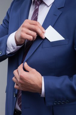 Cheerful young man in suit on meeting