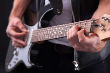 Cheerful male musician is performing on musical instrument